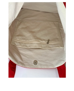 Detail view of canvas tote bag interior with zipper pocket and magnetic snap closure