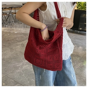 Detail of reddish-brown hollow knit tote bag featuring retro crochet square patterns