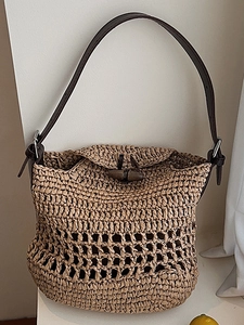 Handwoven straw shoulder bag with leather strap and horn buckle for summer beach resort style