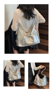 Detailed views of silver pleated tote bag with pink heart pendant and scarf detail