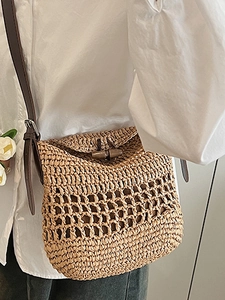 Handwoven straw shoulder bag with leather straps and horn buckle for summer beach vacations