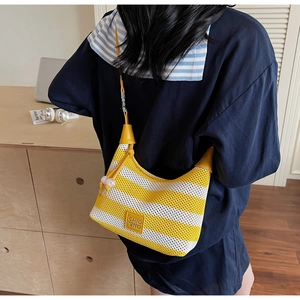 Detail of striped knit shoulder bag with yellow leather logo patch and drawstring
