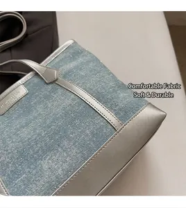 Close-up of light blue denim tote with sparkling rhinestones and silver leather trim