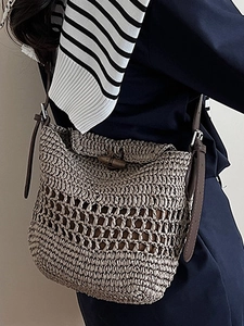 Khaki straw woven crossbody bag with hollow grid pattern and wooden buckle closure