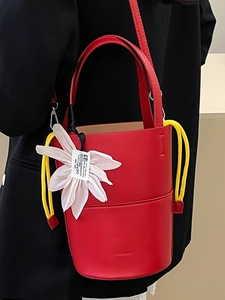 Fashionable red flower bucket bag with yellow drawstring and white floral charm for women