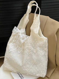 Elegant white lace tote bag with floral patterns and a large bow for a French style