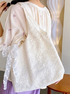White lace tote bag with floral embroidery and large bow knot decoration on shoulder strap