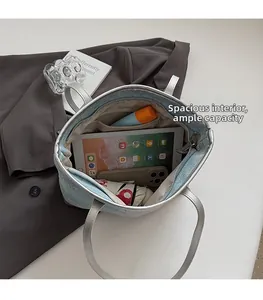 Macro shot of spacious tote bag interior with iPad, umbrella, and water bottle