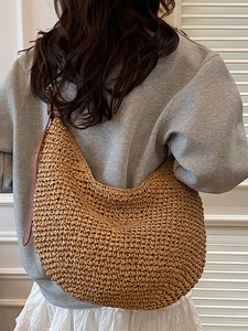 Large crescent straw shoulder bag with brown leather strap for summer beach vacation