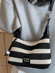 Striped knit hobo bag with leather strap and logo, showing stylish large capacity design