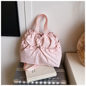 Pink drawstring nylon tote bag featuring multiple pockets and wide fabric handles