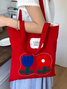 Red canvas tote bag with floral embroidery and be fearless slogan for daily casual wear