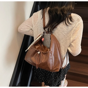 Deep brown soft PU leather tote bag with drawstring pleats and heart charm detail
