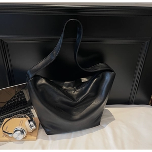 Detail of soft black leather tote bag showing smooth texture and spacious interior