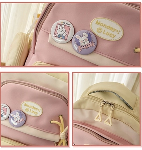 Detail of Korean style pink and beige school backpack with rabbit badges and embroidery