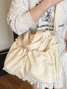 Minimalist beige canvas tote bag with drawstring closure and large capacity for women