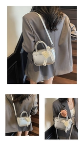 Detail of silver crinkled leather mini tote with pearl lace bow on outdoor stairs