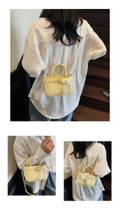 Detail view of yellow lychee-grain tote bag with pearl lace charm and shoulder strap