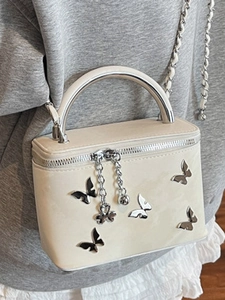 Chic beige box handbag with silver butterfly accents and round top handle