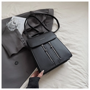 Vue détaillée du sac à dos en cuir noir avec double fermeture éclair et rabat épuré