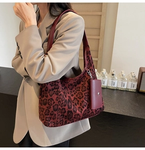 Detail of red-brown leopard print tote bag with mini coin purse and leather strap