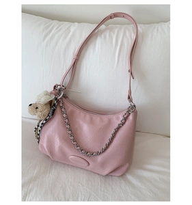 Pink faux leather tote bag detail with silver chain and cute plush bear accessory