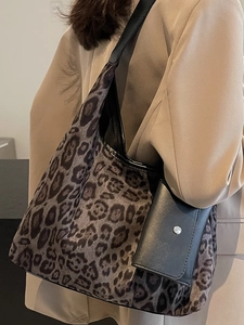 Large leopard print tote bag with black leather straps and matching small pouch