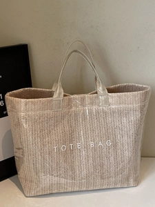 Chic beige woven tote bag with glossy finish and TOTE BAG lettering for daily use