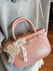 Pink glossy patent leather handbag with pearl heart pendant and ribbon for women