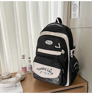 Close-up of dual-tone school backpack with clear PVC pocket and a small round coin purse
