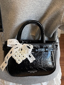 Retro black patent leather handbag with lace bow and pearl heart charm detail