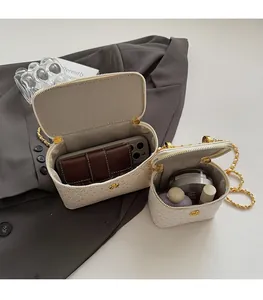 Detail view of white textured chain handbag interior showing spacious storage capacity