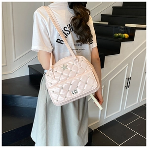 Close-up of pink quilted crossbody bag featuring sparkling star-shaped rhinestones