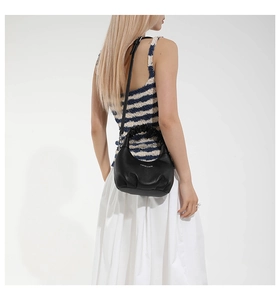 Detail of black ruched handle shoulder bag with Fashion & Bags text on lychee leather