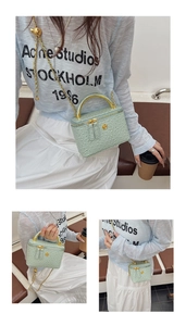 Detail view of light green ostrich texture bag with gold handle and rose metal accent