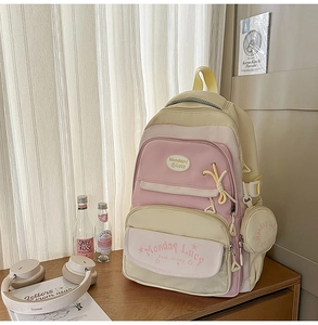 Detail of color-block school backpack with cute pendants in a cozy lifestyle setting