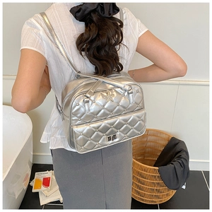 Silver Y2K quilted backpack with rhinestone star detail shown from a back perspective