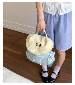 Detail of cute macaron fruit backpack featuring apple-shaped flap and waterproof nylon fabric