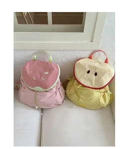 Detail view of macaron color fruit backpacks with watermelon and apple embroidery