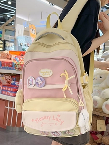 Pink and yellow school backpack for girls with cute rabbit badge and plush charm