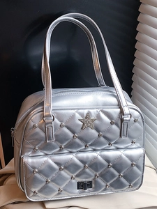 Silver quilted shoulder bag with diamond star and metal twist lock in minimalist setting
