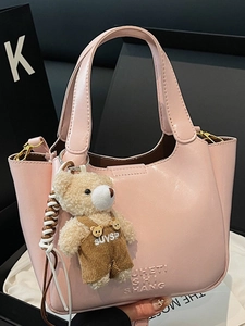 Pink oily wax leather bucket bag for women featuring a cute brown teddy bear charm accessory