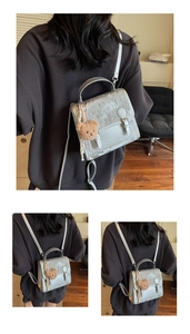Silver PU backpack with belt buckle flap, rhinestone accents and a brown bear charm