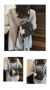 Black polka dot shoulder bag with silver buckle and cute plush bear accessory