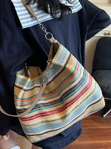Large colorful woven tote bag with striped pattern and chain strap on shoulder