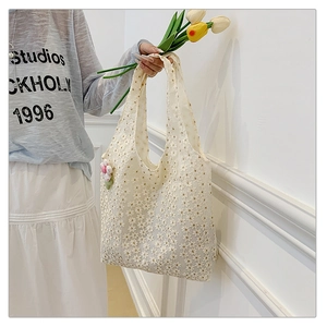 Detailed look at the off-white lace tote bag with floral embroidery and 3D flower charm