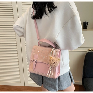 Pink PU and suede crossbody bag with glitter details and a cute brown bear charm