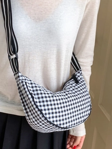 Fashionable black and white checkered dumpling crossbody bag with adjustable strap