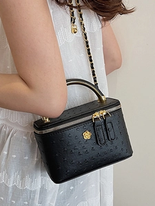 Fashionable black ostrich texture box bag with gold chain and floral logo detail