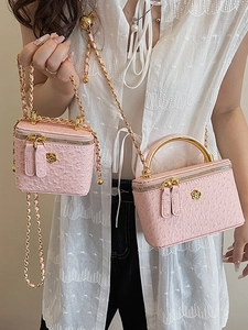 Pink ostrich pattern mini box bag with gold chain strap and floral metal buckle detail
